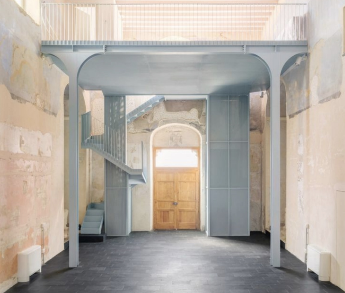 Bom Tom — restored interior, blue-grey structure amid pastel plaster